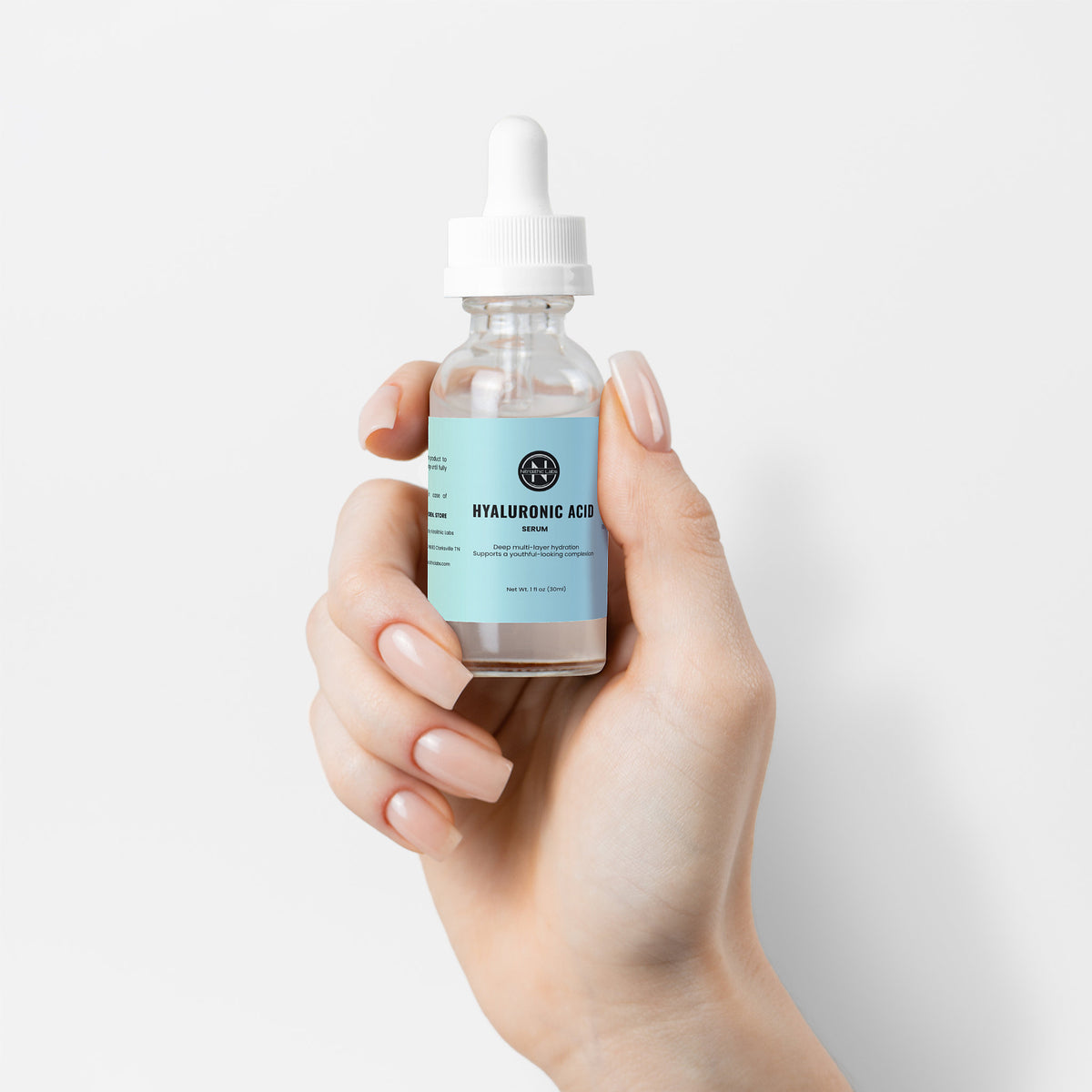 Hyaluronic Acid Serum dropper bottle held in hand