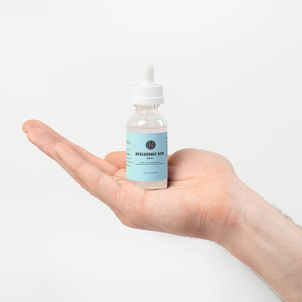Hyaluronic Acid Serum dropper bottle displayed on open palm