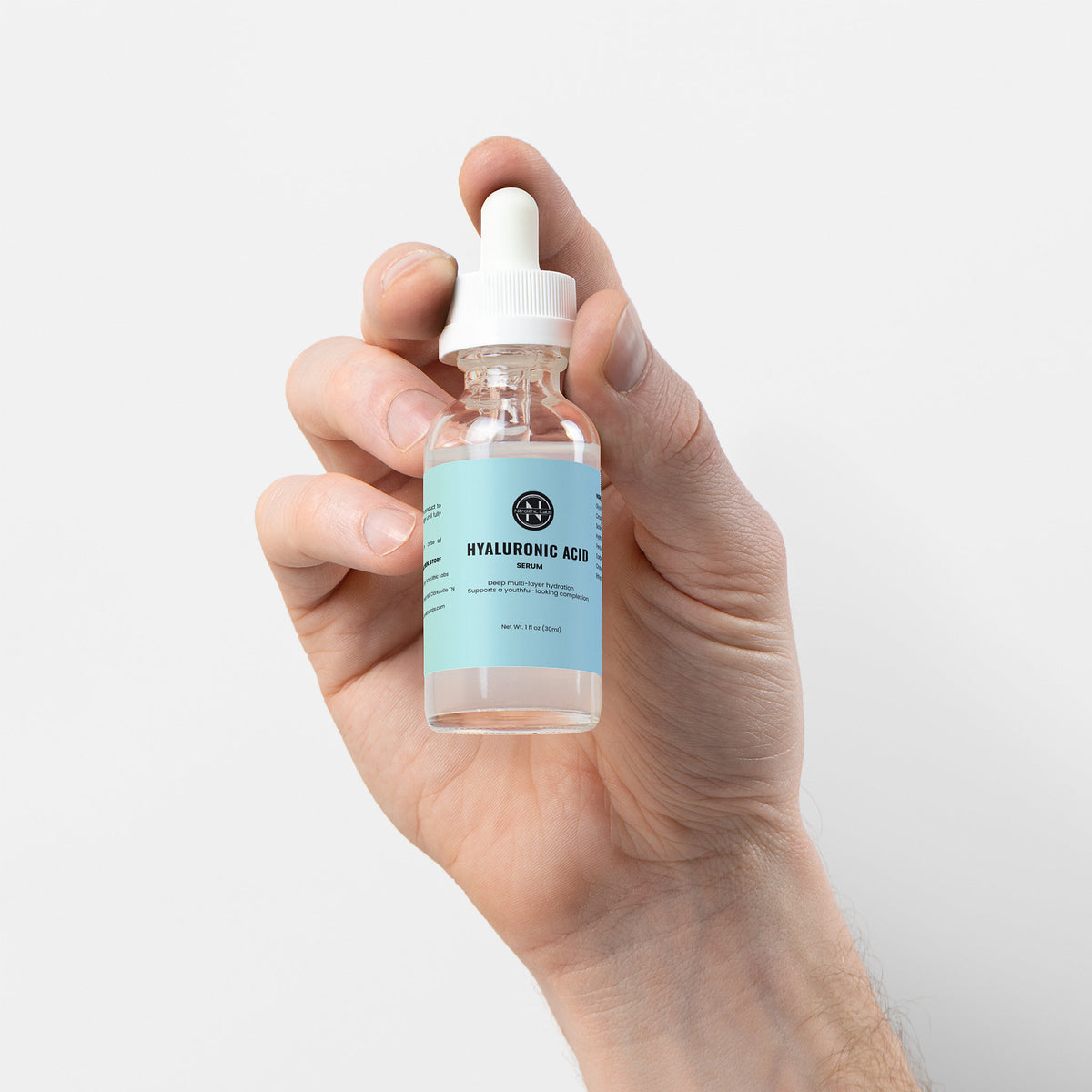 Hyaluronic Acid Serum dropper bottle held in hand